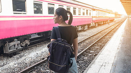 Lonely woman on train platform of railway station her feel homesick