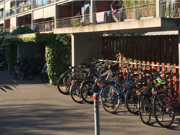 Covered bicycle parking in front of the Laubenhaus in Burgunder